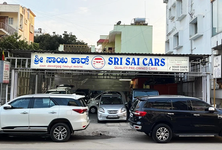 Certified multi-brand second hand cars parked inside Sri Sai Cars showroom in Arekere Bengaluru.